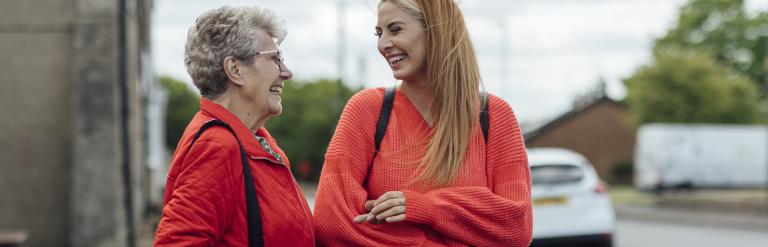 Older woman with younger woman smiling and laughing