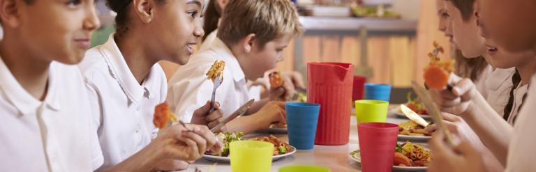 several school age children eating together